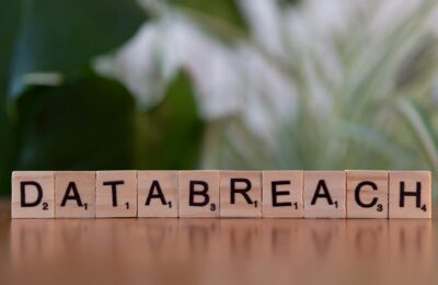 Close-up of Scrabble tiles spelling 'data breach' on a blurred background