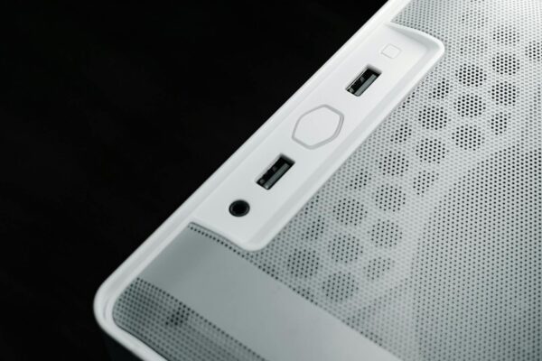 Detailed view of USB and audio ports on a white computer case, showcasing modern technology design.
