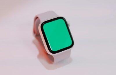 Smartwatch with a blank green screen displayed on a light background, suitable for mockups.