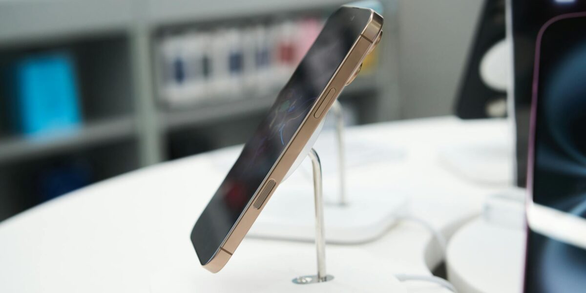 Side view of a modern smartphone showcased in a retail store.