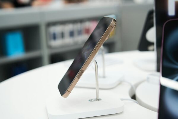Side view of a modern smartphone showcased in a retail store.
