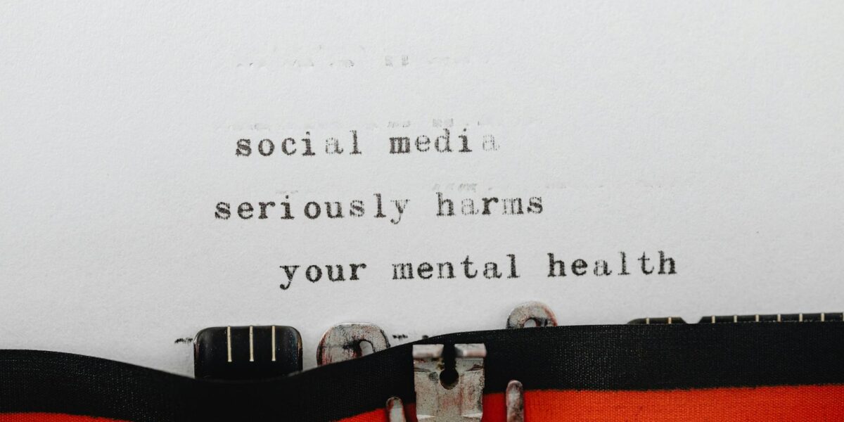 Vintage typewriter conveying message on social media's impact on mental health.
