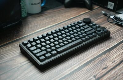 A sleek black mechanical keyboard placed on a wooden desk, ideal for gaming or office use.