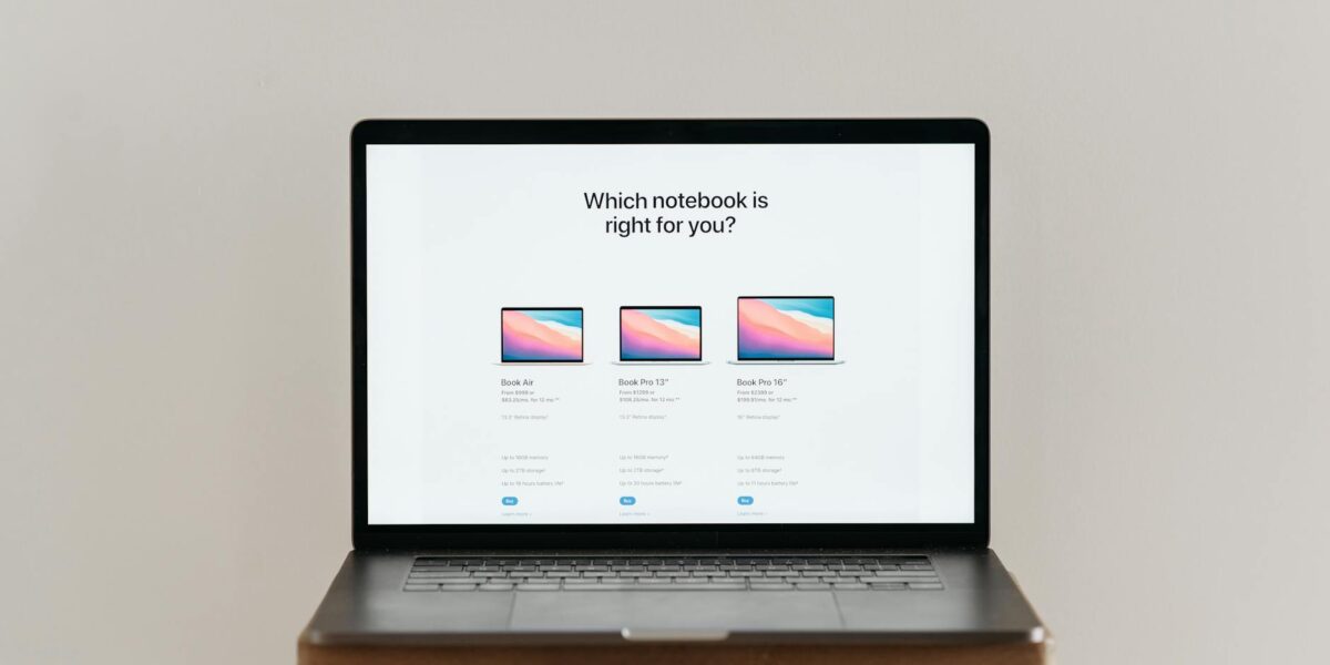 An open laptop on a wooden stool showing a notebook comparison chart, ideal for tech-focused imagery.
