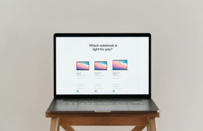 An open laptop on a wooden stool showing a notebook comparison chart, ideal for tech-focused imagery.