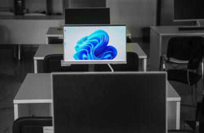 A contemporary office setup featuring computers on desks with modern flat screens.