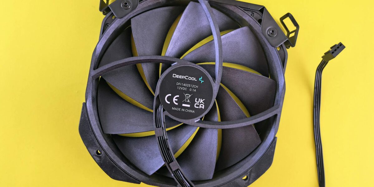 Black computer cooling fan with wire on vibrant yellow background. Ideal for technology content.