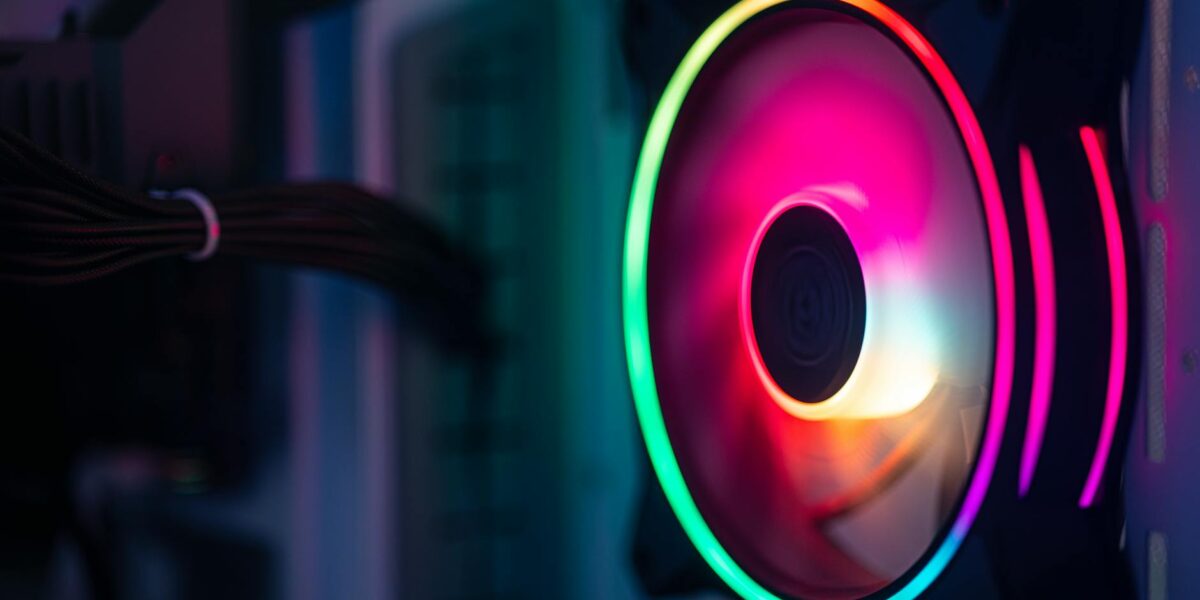 Close-up of a colorful RGB cooling fan in a gaming PC setup.