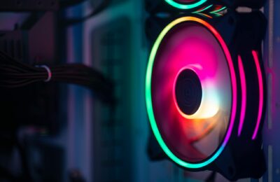 Close-up of a colorful RGB cooling fan in a gaming PC setup.