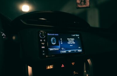 Close-up view of a car's dashboard at night displaying Bluetooth audio system.