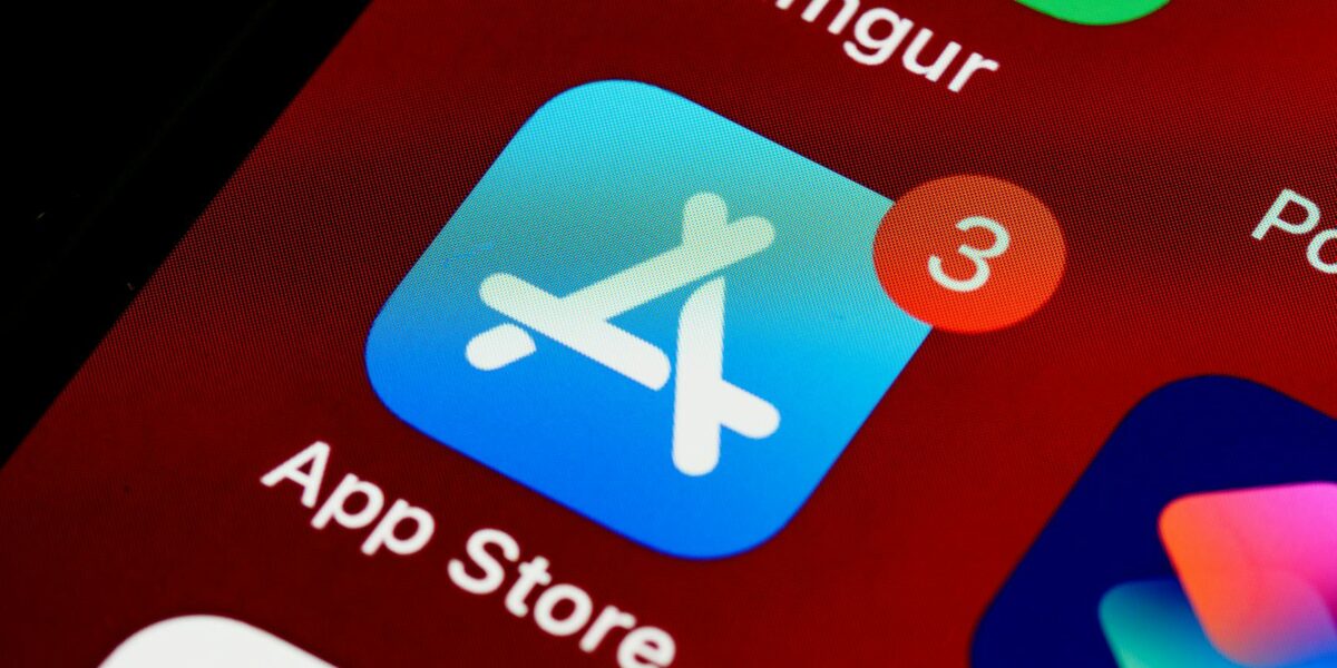 Close-up of App Store icon on iPhone screen with notification badge, highlighting app updates.
