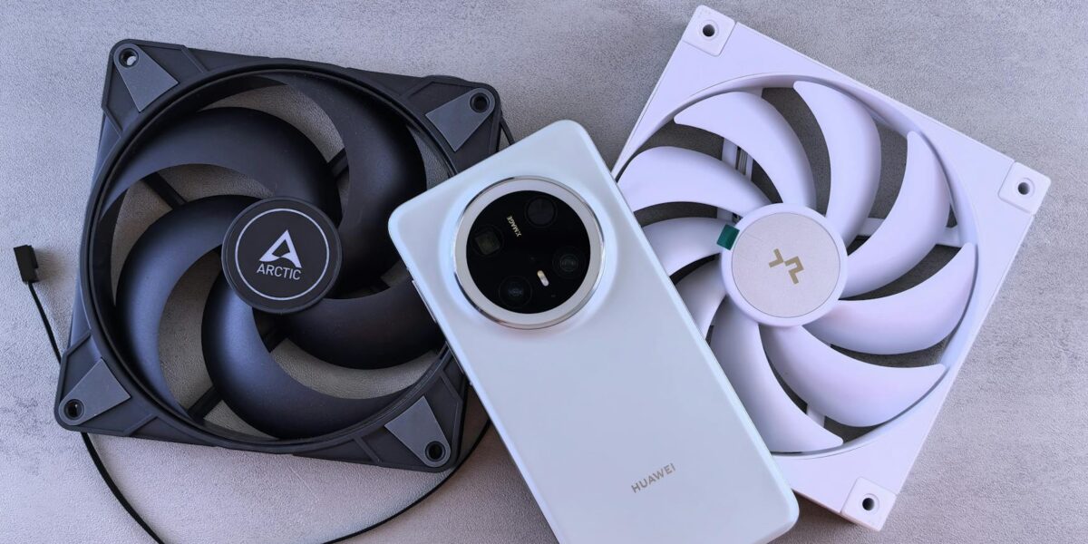 Image of a smartphone alongside two cooling fans on a textured gray surface.
