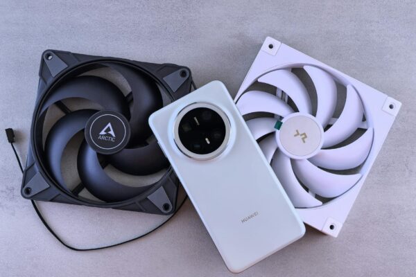 Image of a smartphone alongside two cooling fans on a textured gray surface.