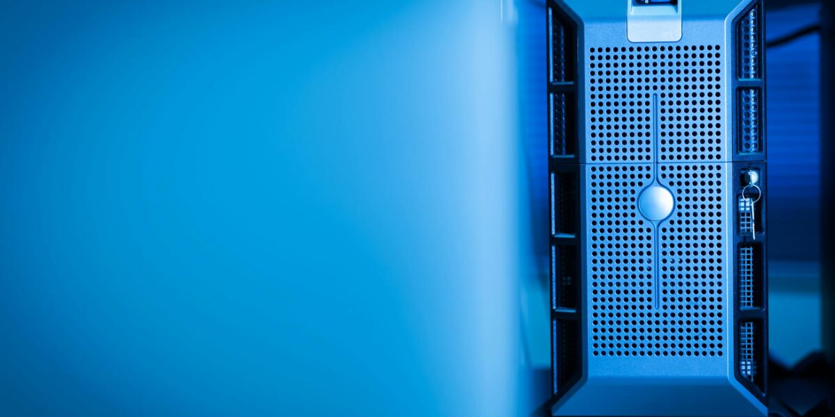 Close-up of a modern server unit in a blue-lit data center environment.