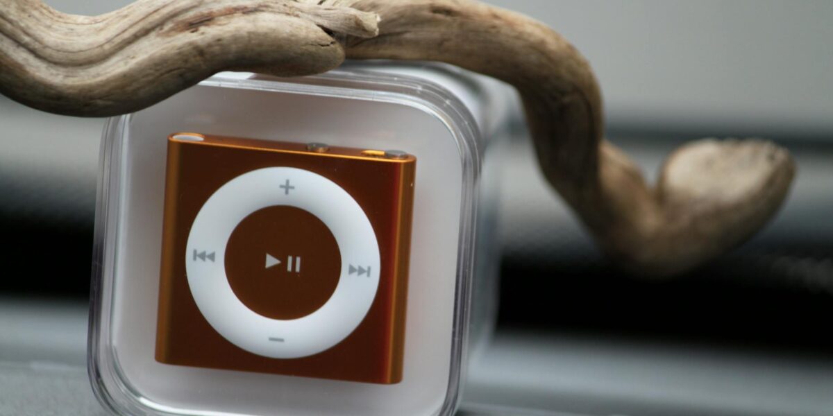 Close-up of a compact music player encased in clear plastic with wooden element.