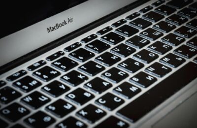 Detailed close-up of a MacBook Air keyboard featuring Cyrillic characters, capturing sleek technology.