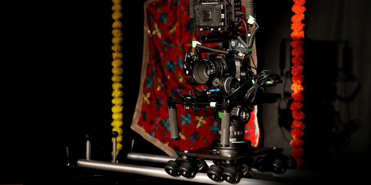 A professional camera rig setup in a vibrant studio space with colorful decorations.