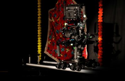 A professional camera rig setup in a vibrant studio space with colorful decorations.