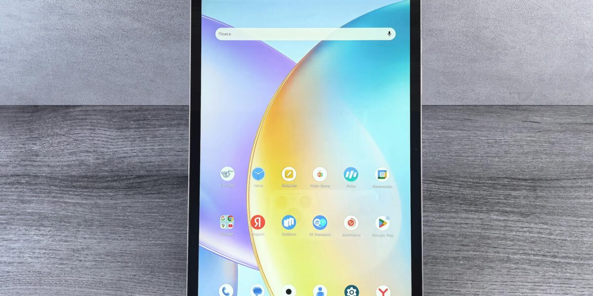 Front view of a modern tablet showing a colorful home interface with various app icons on display.