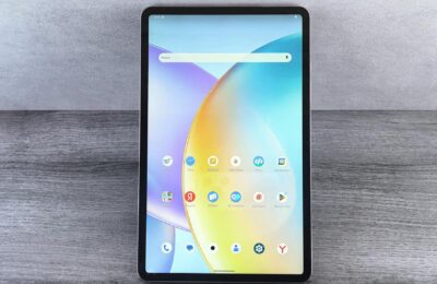 Front view of a modern tablet showing a colorful home interface with various app icons on display.