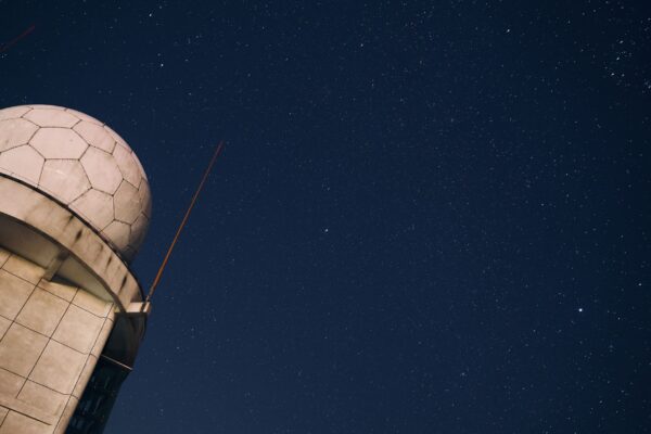 A stunning view of a starry night sky above an observatory dome, capturing the beauty of the cosmos.