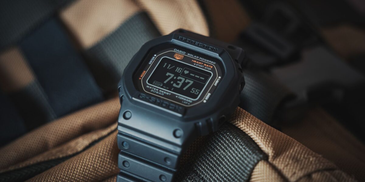 Close-up of a Casio G-Shock wristwatch resting on a textured backpack, ideal for outdoor adventures.