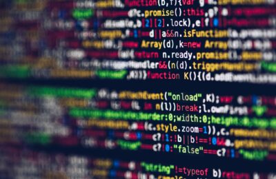 Vivid, blurred close-up of colorful code on a screen, representing web development and programming.