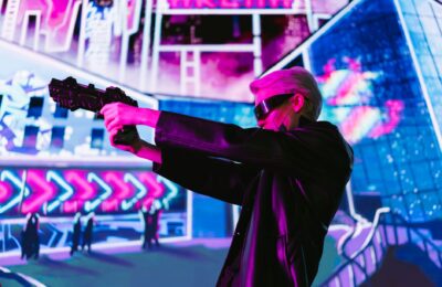 Person in cyberpunk attire aims futuristic gun in neon-lit scene