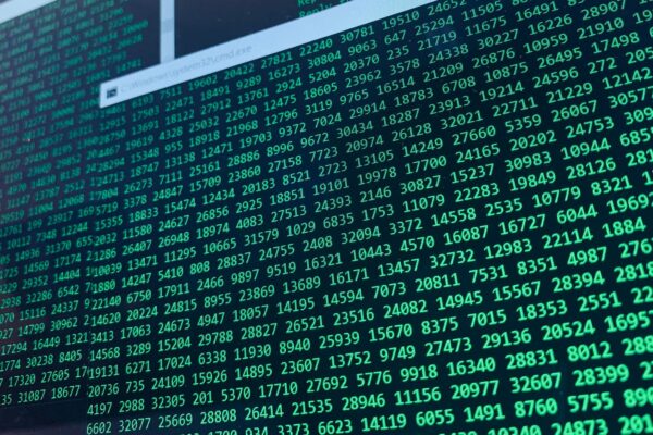 Vibrant green numbers on a computer screen, showcasing binary code and data streams.