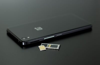 Close-up of a smartphone with a SIM card and memory card, showcasing modern technology.