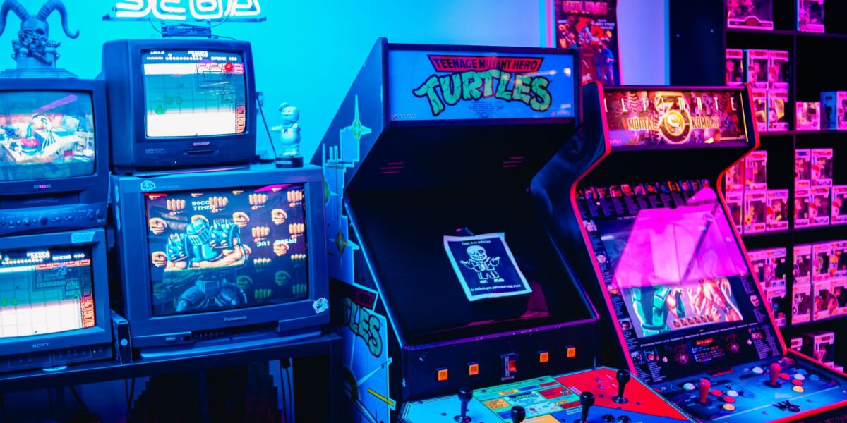 A vibrant retro arcade room featuring classic gaming machines and colorful neon lighting.