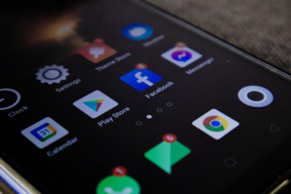 Detailed view of a smartphone screen with popular app icons including Facebook and Messenger.