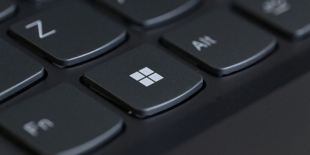 Detailed close-up of a computer keyboard featuring the Windows key in focus.