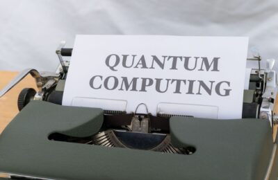 A vintage typewriter with a paper displaying the term Quantum Computing.