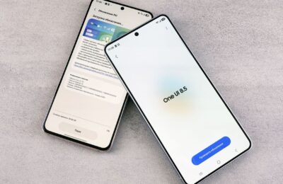 Two smartphones are shown displaying a software update screen with One UI 8.5.