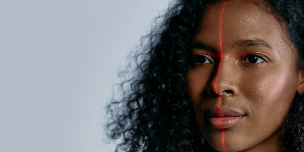 Close-up of a woman scanned with a laser for facial recognition, showcasing advanced technology.