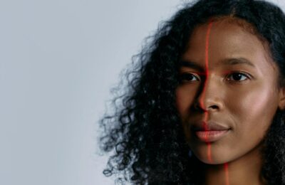Close-up of a woman scanned with a laser for facial recognition, showcasing advanced technology.