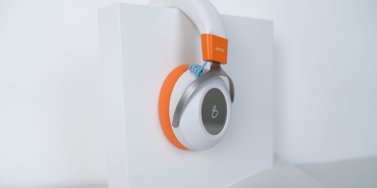 Stylish over-ear headphones with an orange accent, perfect for tech enthusiasts.