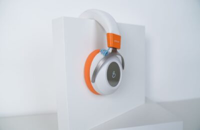 Stylish over-ear headphones with an orange accent, perfect for tech enthusiasts.