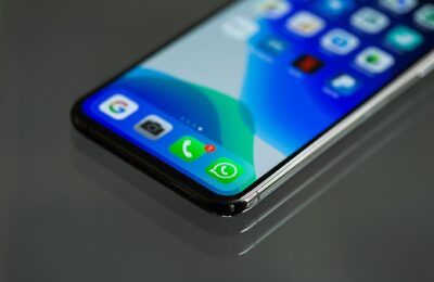 Close-up shot of a smartphone screen displaying various app icons including WhatsApp.