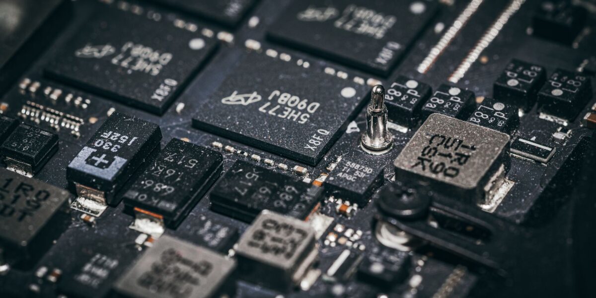 Detailed close-up of electronic microchips on a circuit board, showcasing technology and engineering intricacies.