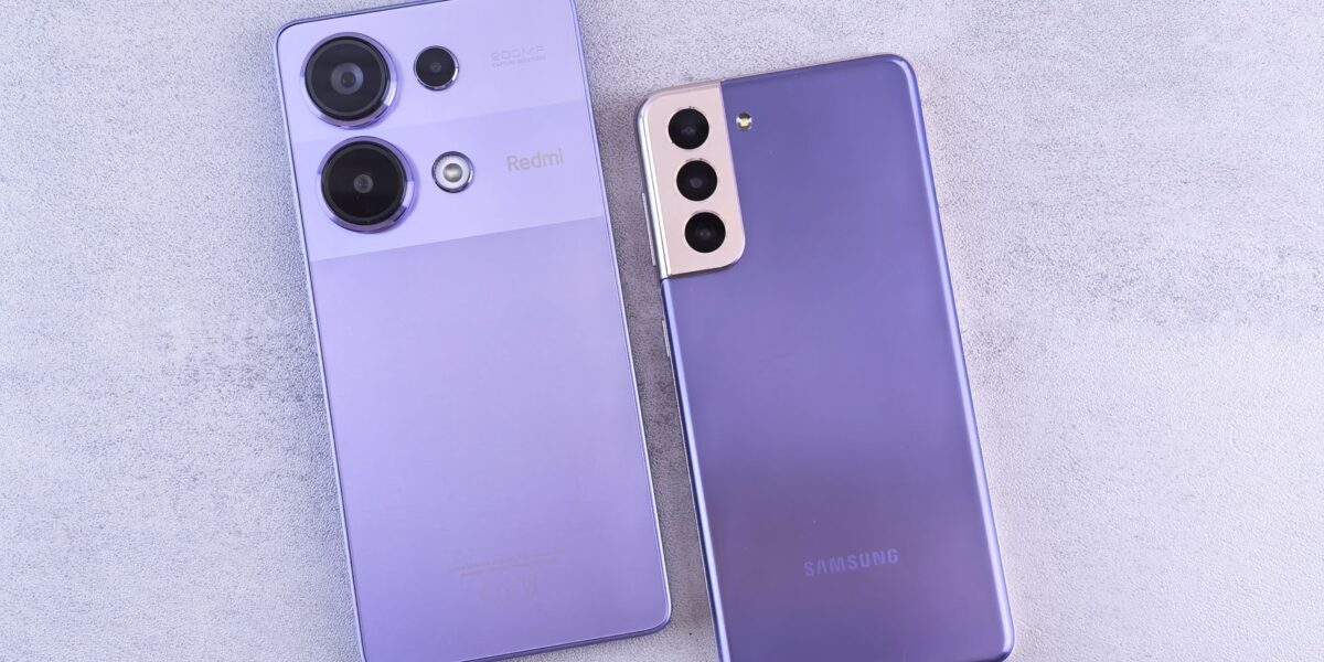 Detailed image showcasing two purple smartphones on a light surface.