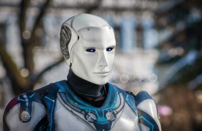 Close-up of a futuristic humanoid robot with metallic armor and blue LED eyes.