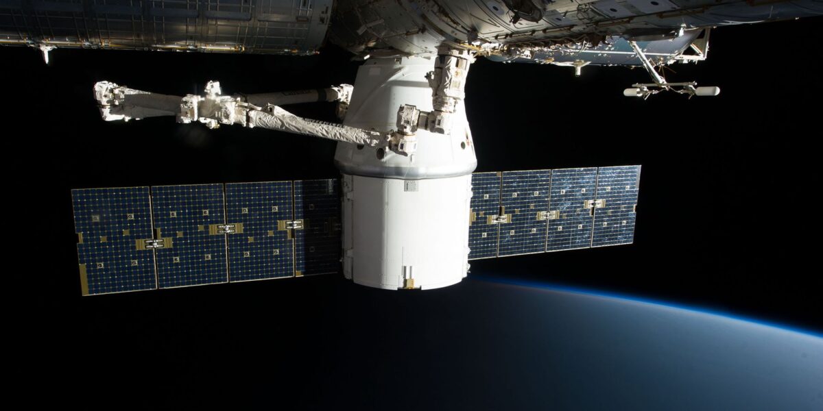Image of the International Space Station floating above Earth with visible solar panels.