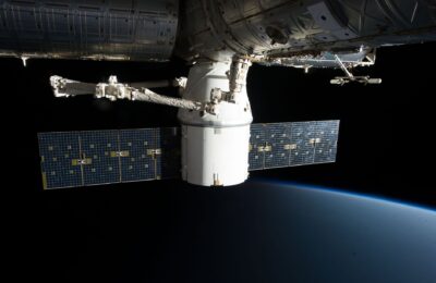 Image of the International Space Station floating above Earth with visible solar panels.