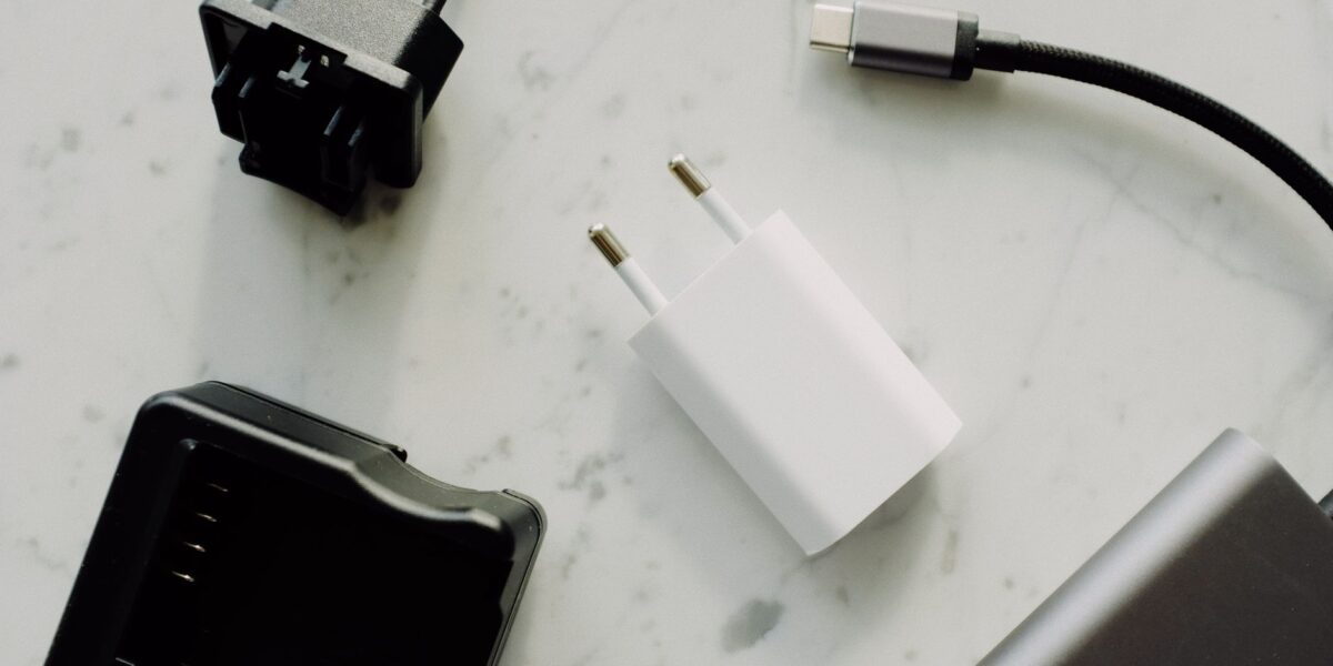 Close-up of USB-C and adaptors on a marble surface, highlighting modern electronics essentials.