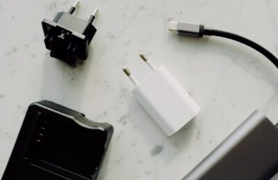 Close-up of USB-C and adaptors on a marble surface, highlighting modern electronics essentials.