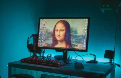 Mona Lisa on a computer desktop in a tech-inspired gaming setup with vibrant LED lighting.