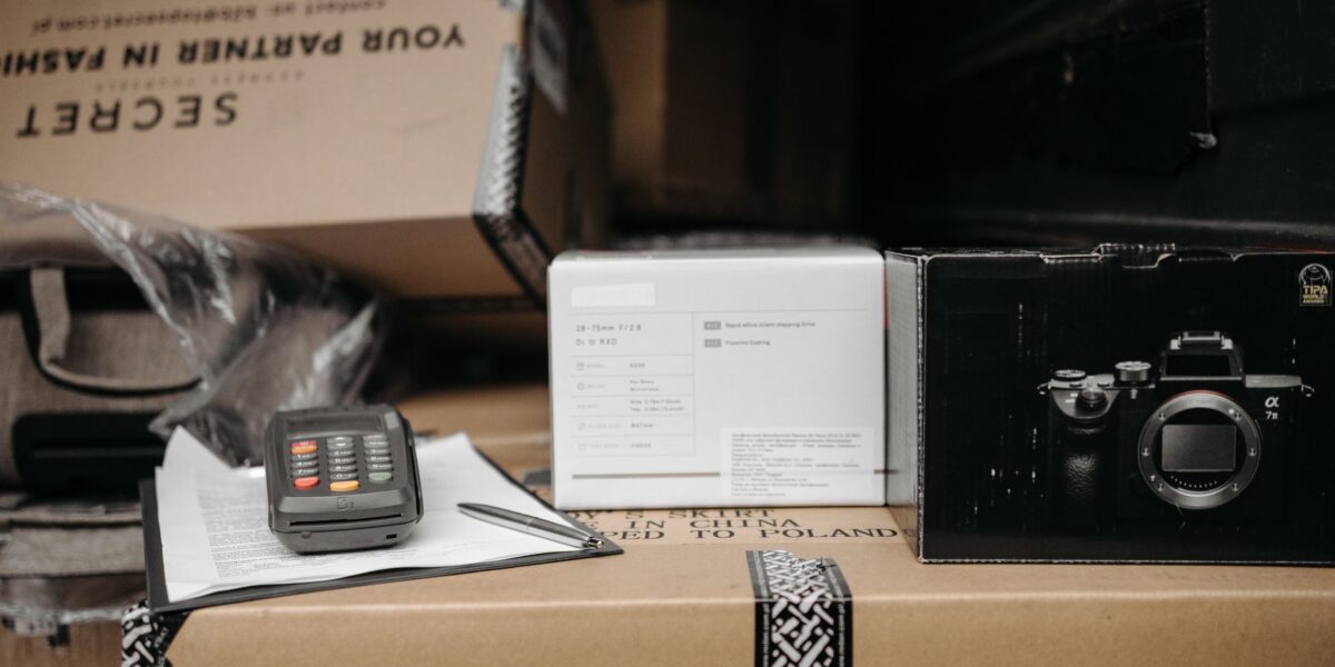 Assorted packages with camera equipment ready for shipment in an indoor setting.