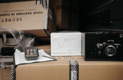 Assorted packages with camera equipment ready for shipment in an indoor setting.